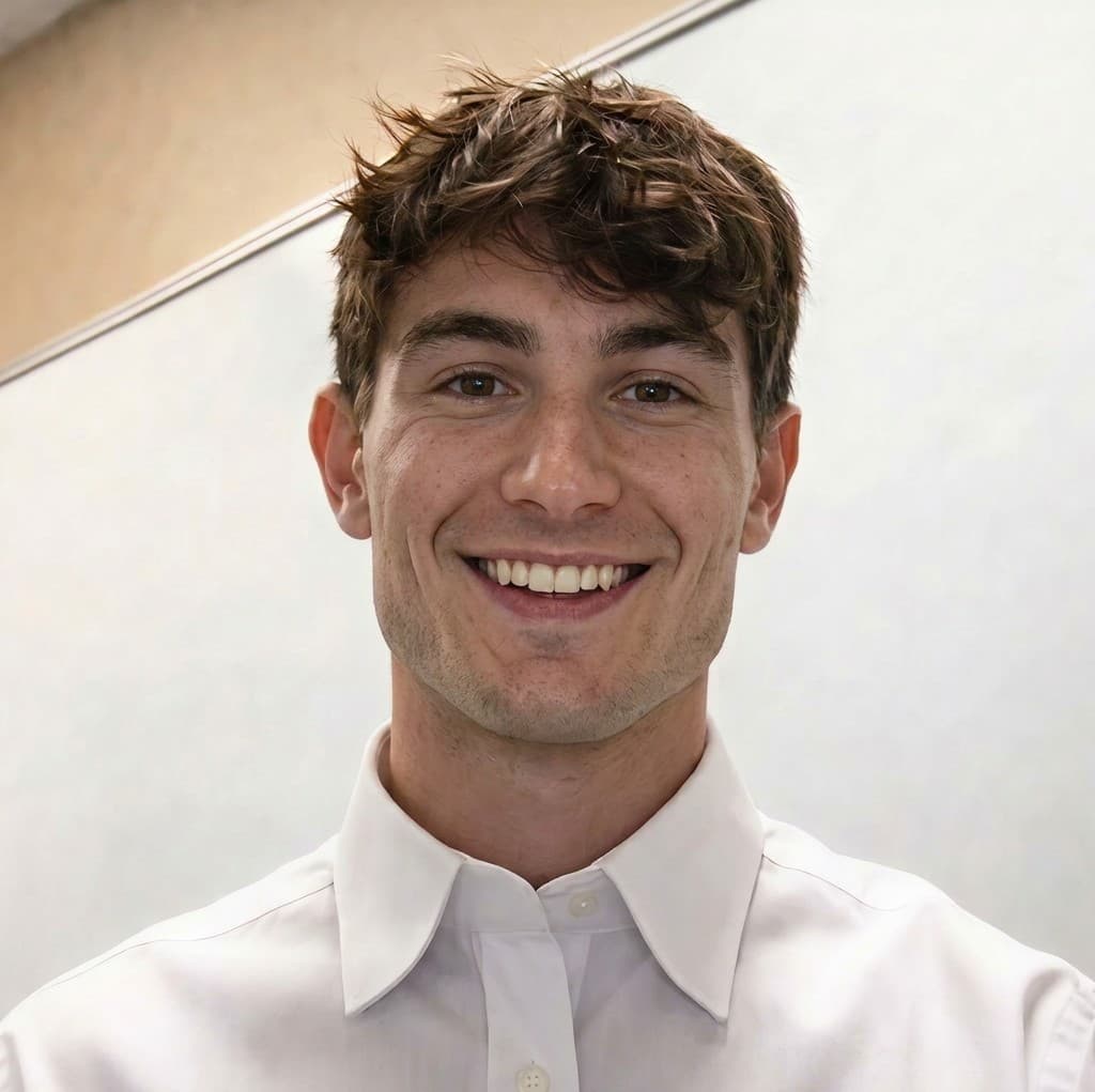 גבר צעיר מחייך בחולצה לבנה